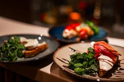 three plates of food sitting on a table at Coco Suite Private Spa and Jacuzzi Prague Center in Prague