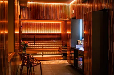 a room with a table and a chair and stairs at Coco Suite Private Spa and Jacuzzi Prague Center in Prague
