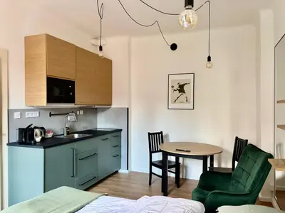 a kitchen with a sink and a table in a room at Urban Studio - Tram Stop at Your Door, Metro 5-min Walk in Prague