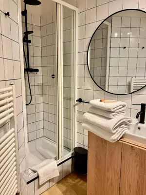 a bathroom with a sink and a shower and towels at Urban Studio - Tram Stop at Your Door, Metro 5-min Walk in Prague