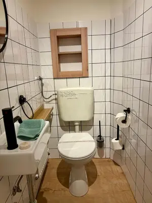 a bathroom with a white toilet and a sink at Urban Studio - Tram Stop at Your Door, Metro 5-min Walk in Prague