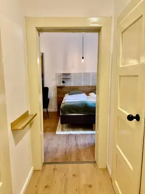a bedroom with a bed and a door leading into a room at Urban Studio - Tram Stop at Your Door, Metro 5-min Walk in Prague