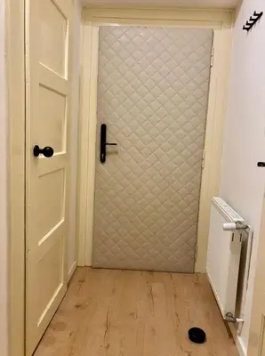 a glass door in a hallway with a wooden floor at Urban Studio - Tram Stop at Your Door, Metro 5-min Walk in Prague