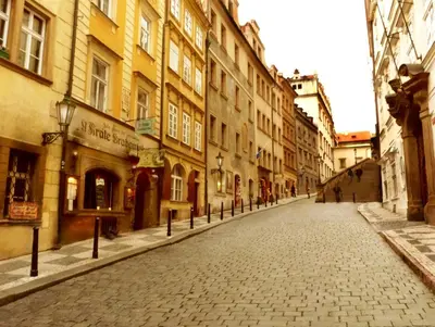 an empty street in a city with buildings at Apartments U Krále Brabantského in Prague