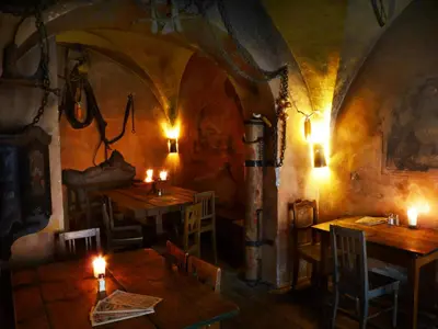 a restaurant with tables and candles in a room at Apartments U Krále Brabantského in Prague