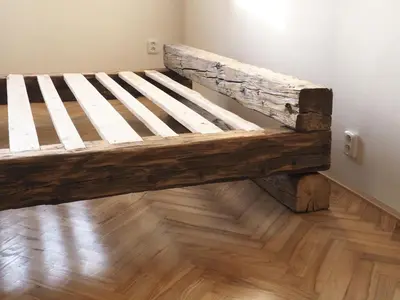 a wooden bed sitting on top of a wooden floor at Stylish studio near Jezerka park in Prague