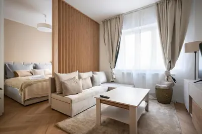 a living room with a couch and a bed at Place of Grace - Anděl 1 min to subway in Prague