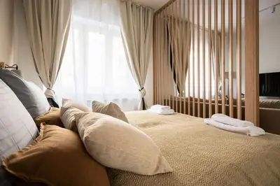 a bedroom with a bed with pillows and a window at Place of Grace - Anděl 1 min to subway in Prague