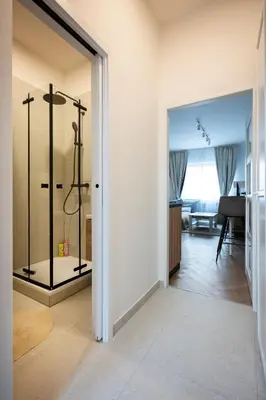 a bathroom with a glass shower in a room at Place of Grace - Anděl 1 min to subway in Prague