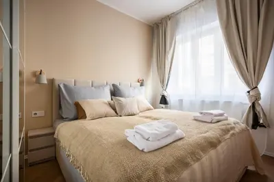 a bedroom with a large bed with towels on it at Place of Grace - Anděl 1 min to subway in Prague