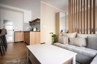 a living room with a couch and a table at Place of Grace - Anděl 1 min to subway in Prague