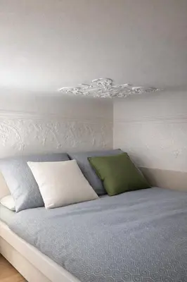 a bed with two pillows on top of it at Design Loft near National Theatre in Prague