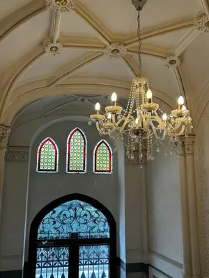 a large room with a chandelier and stained glass at Design Loft near National Theatre in Prague