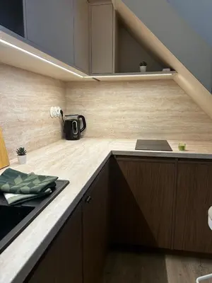 a kitchen with wooden cabinets and a counter top at Design Loft near National Theatre in Prague
