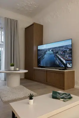 a living room with a large flat screen tv at Design Loft near National Theatre in Prague