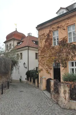 a cobblestone street in front of two buildings at Apartment Trziste in Prague