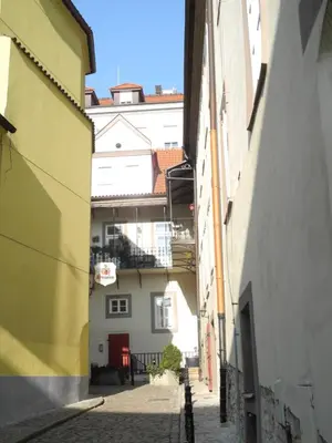 an alley between two buildings in a city at Apartment Trziste in Prague