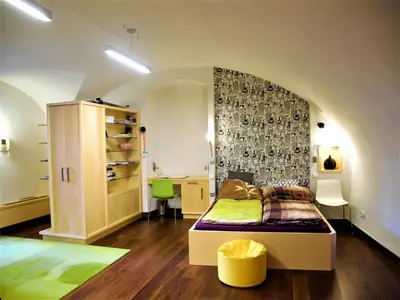 a bedroom with a bed in a room at Apartment Trziste in Prague