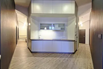 a kitchen with white cabinets and a sink at DeLuxe Apartment in Prague