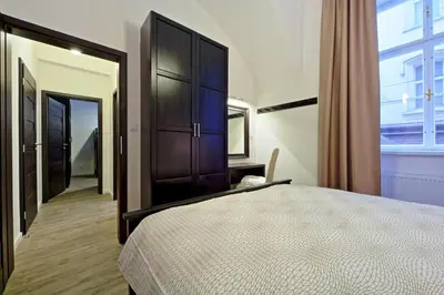 a bedroom with a large bed and a large window at DeLuxe Apartment in Prague