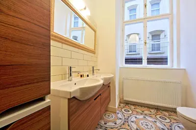 a bathroom with two sinks and a mirror at DeLuxe Apartment in Prague