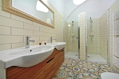 a bathroom with two sinks and a shower at DeLuxe Apartment in Prague