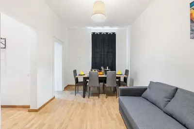 a living room with a couch and a table with chairs at Big Boss Apartment in Prague