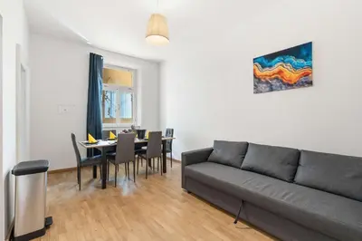 a living room with a couch and a table with chairs at Big Boss Apartment in Prague