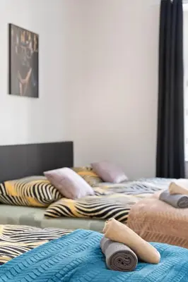 a group of three beds sitting next to each other at Big Boss Apartment in Prague