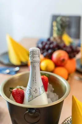 a bucket with a bottle of milk and strawberries at Big Boss Apartment in Prague
