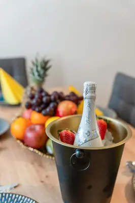 a bucket full of fruit with a bottle in it at Big Boss Apartment in Prague