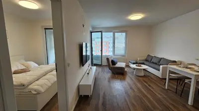 a bedroom with a bed and a couch and a table at Klamovka stylish Apartment by Rentez in Prague