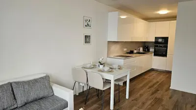 a living room with a white table and a couch at Klamovka stylish Apartment by Rentez in Prague