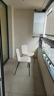 two white chairs in a room with a window at Klamovka stylish Apartment by Rentez in Prague