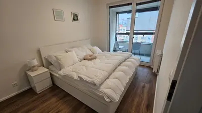 a bedroom with a bed with a teddy bear on it at Klamovka stylish Apartment by Rentez in Prague