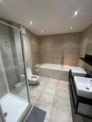 a bathroom with a tub and a toilet and a sink at Kroftova12 in Prague