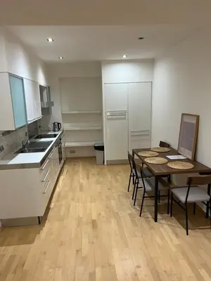 a kitchen and dining room with a table and chairs at Kroftova12 in Prague