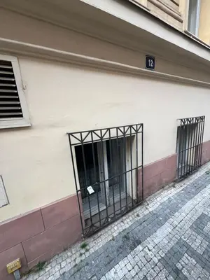 an iron gate on the side of a building at Kroftova12 in Prague