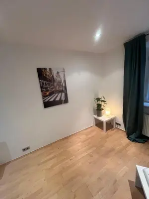 a room with white walls and a wooden floor at Kroftova12 in Prague