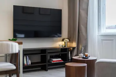 a kitchen with white cabinets and a counter top at Rentero Modern Spacious Apartment in Central Prague in Prague