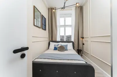 a living room with a couch and a tv at Rentero Modern Spacious Apartment in Central Prague in Prague