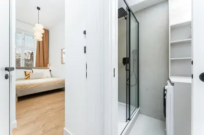 a living room with a dining room table and a kitchen at Rentero Modern Spacious Apartment in Central Prague in Prague