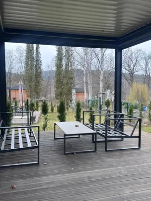 a patio with two benches and a table on a deck at Green Resort Slapy