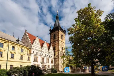 a building with a clock tower in front of it at Luxurious Studio at New Town By Wishlist Prague in Prague