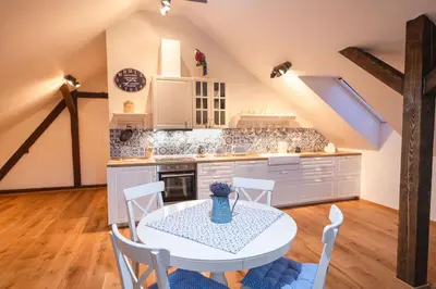 a kitchen with a white table and chairs at Farma Mlýn Drásov in Drásov