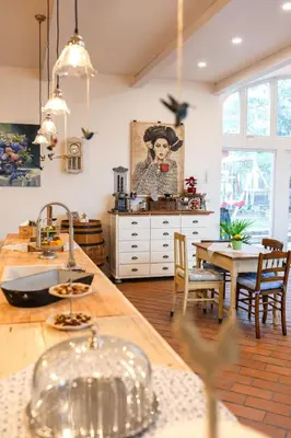 a kitchen with a sink and a table with chairs at Farma Mlýn Drásov in Drásov