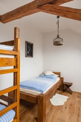a bedroom with two bunk beds and a lamp at Farma Mlýn Drásov in Drásov