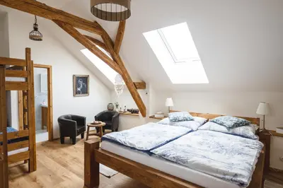 a bedroom with a bed in a attic at Farma Mlýn Drásov in Drásov