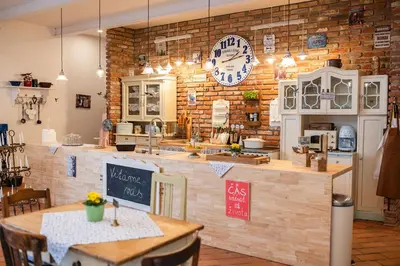 a kitchen with a counter with a table and a counter top at Farma Mlýn Drásov in Drásov