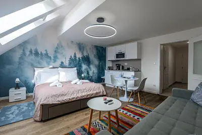 a bedroom with a bed and a couch and a table at Cozy Forest Studio - Calm - Central - Stylish in Prague